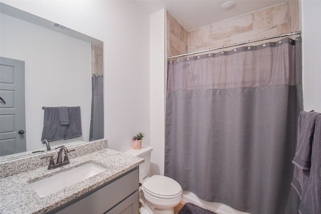 full bathroom featuring vanity, shower / tub combo, and toilet