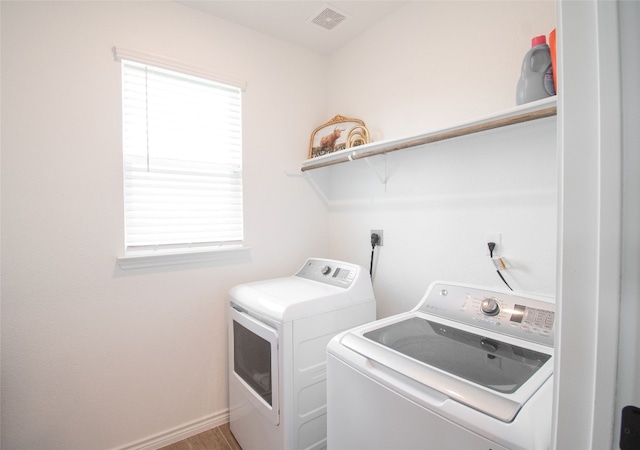 laundry room featuring hardwood / wood-style floors and separate washer and dryer