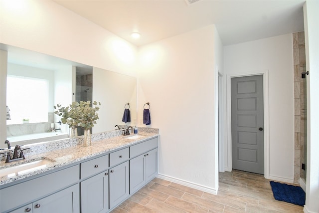 bathroom featuring vanity and shower with separate bathtub