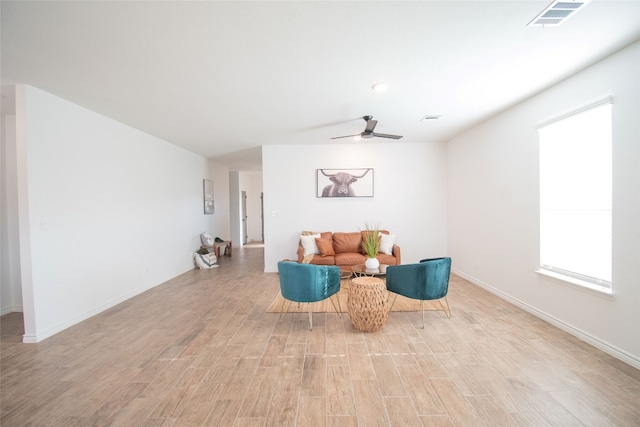 sitting room featuring ceiling fan and light wood-type flooring