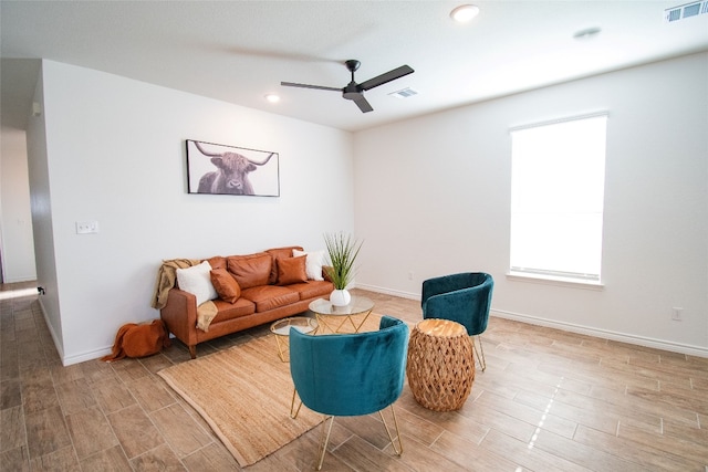 living room with ceiling fan and hardwood / wood-style flooring