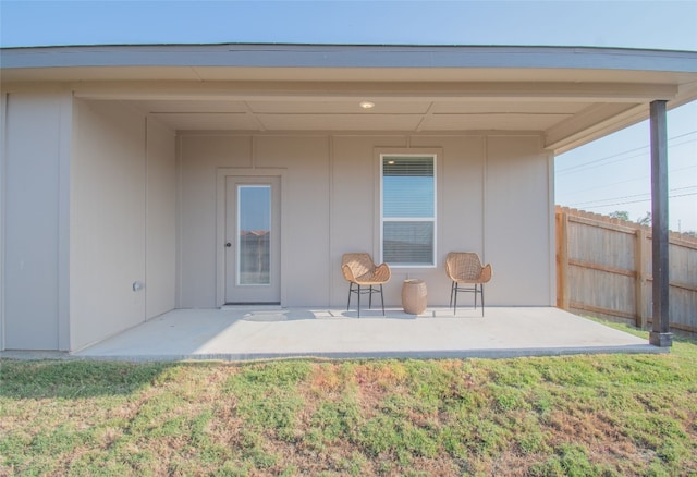 back of house with a lawn and a patio area