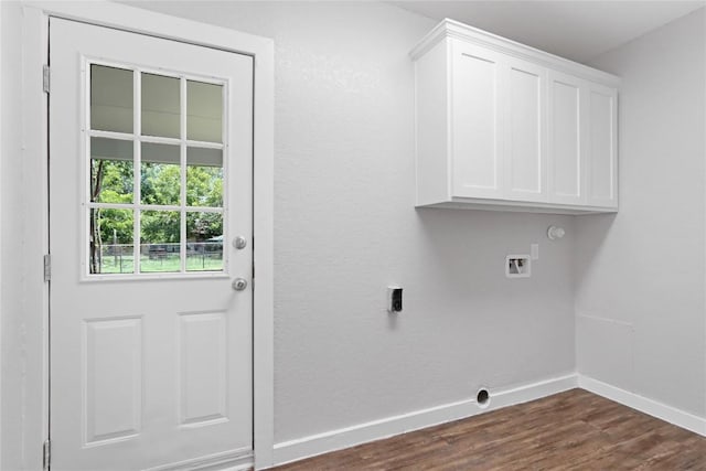 washroom featuring washer hookup, dark wood finished floors, hookup for an electric dryer, baseboards, and cabinet space