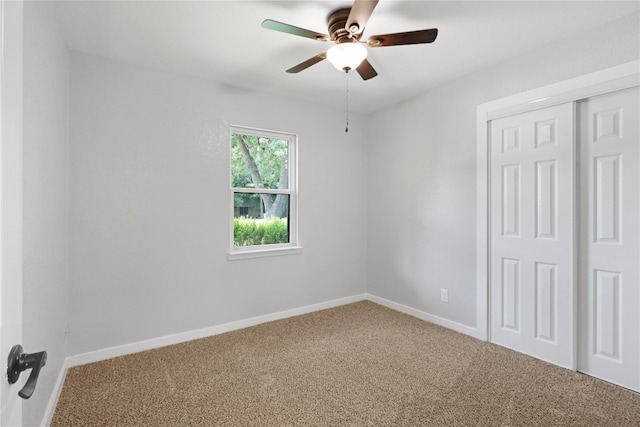 unfurnished bedroom featuring a closet, carpet floors, and ceiling fan