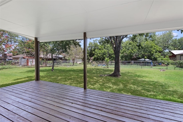 wooden terrace featuring a yard