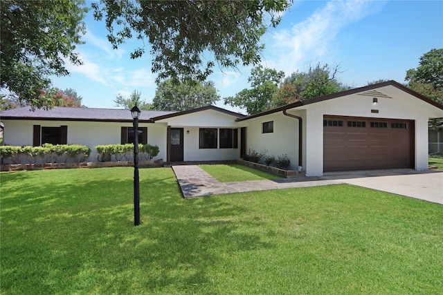 ranch-style home featuring a garage and a front lawn