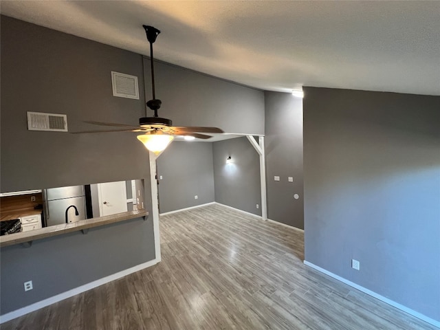 interior space with ceiling fan and hardwood / wood-style floors