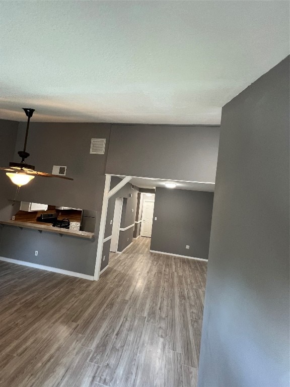 empty room with hardwood / wood-style flooring and ceiling fan