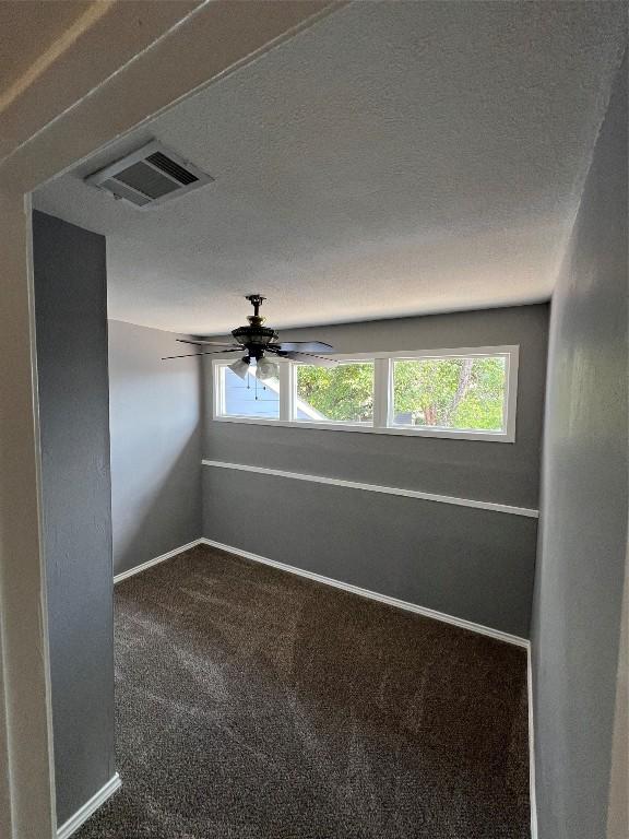 empty room featuring carpet floors, a textured ceiling, and ceiling fan