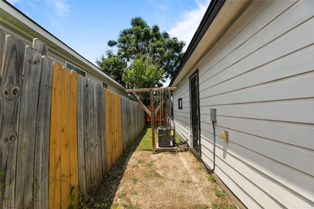 view of side of property featuring central air condition unit