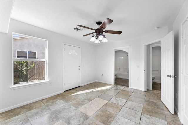 4515 Blue Meadow Dr, Austin, TX 78744 - entrance foyer with ceiling fan and light stone finish flooring
