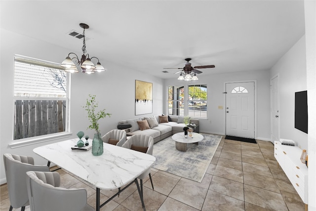 living room with light tile patterned floors and ceiling fan with notable chandelier