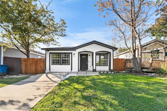 ranch-style house with a front lawn and a porch