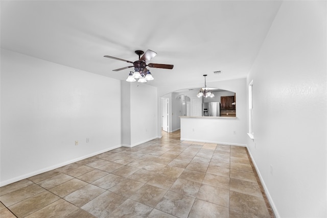 unfurnished living room with ceiling fan with notable chandelier