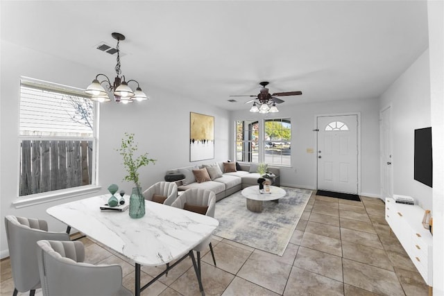 4515 Blue Meadow Dr, Austin, TX 78744 - living area featuring a chandelier, a ceiling fan, and light tile patterned floors