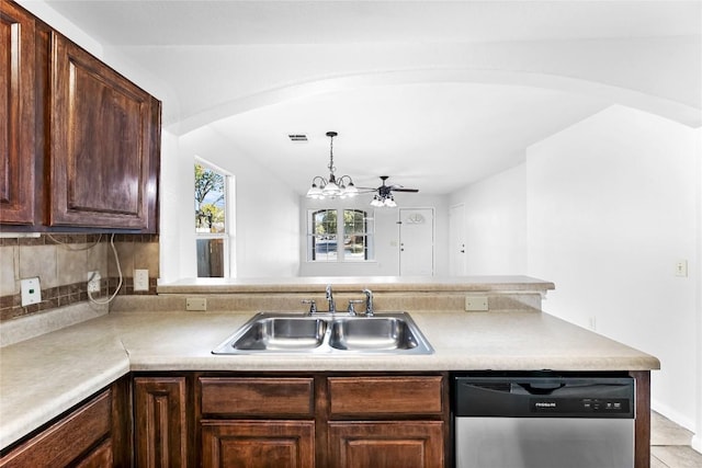 4515 Blue Meadow Dr, Austin, TX 78744 - kitchen with stainless steel dishwasher, arched walkways, light countertops, dark brown cabinetry, and a chandelier