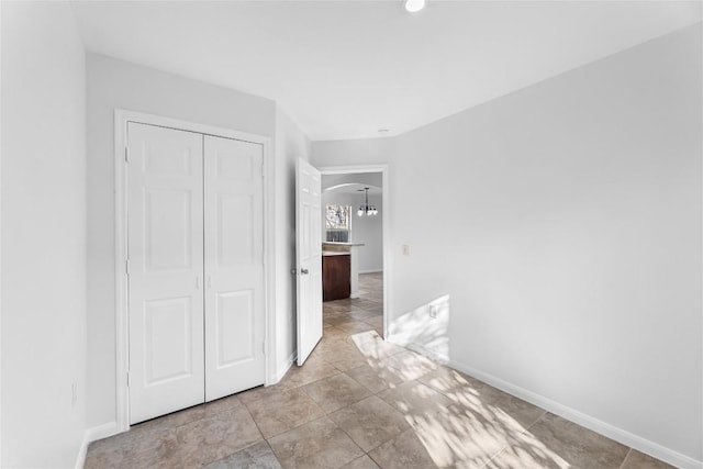 4515 Blue Meadow Dr, Austin, TX 78744 - unfurnished bedroom with arched walkways, a closet, and a chandelier