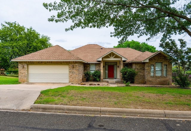 ranch-style home with a garage and a front lawn