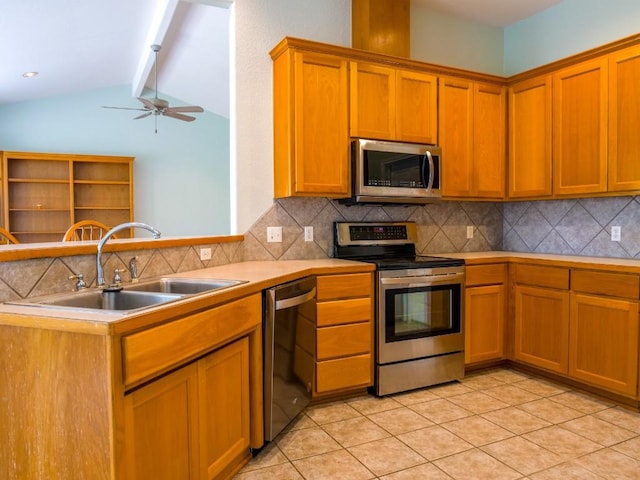 kitchen featuring decorative backsplash, appliances with stainless steel finishes, a sink, light countertops, and vaulted ceiling with beams