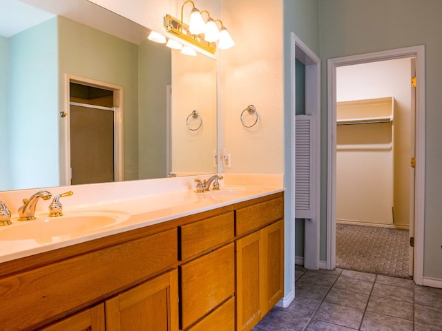 bathroom with dual vanity and tile patterned floors