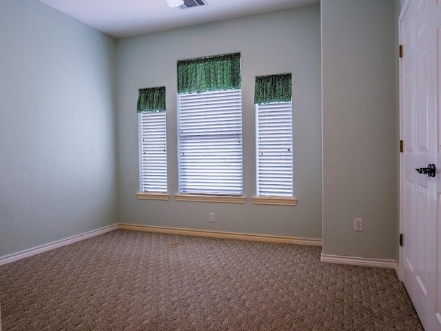 carpeted empty room with baseboards and visible vents