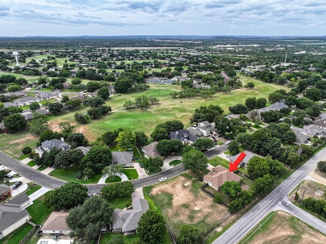 drone / aerial view with view of golf course and a residential view