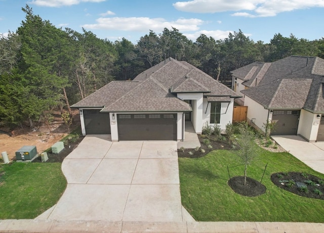 view of front of home featuring a garage and a front yard