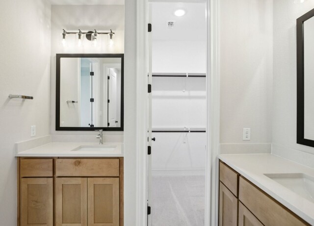 151 William Hersee Dr, Bastrop, TX 78602 - bathroom with two vanities and a walk in closet