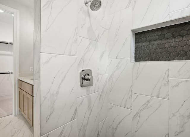 bathroom with vanity and tiled shower