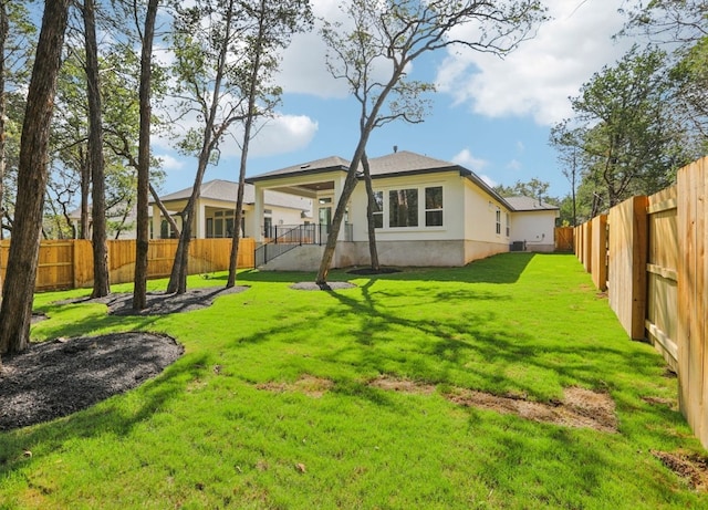 rear view of property featuring a yard