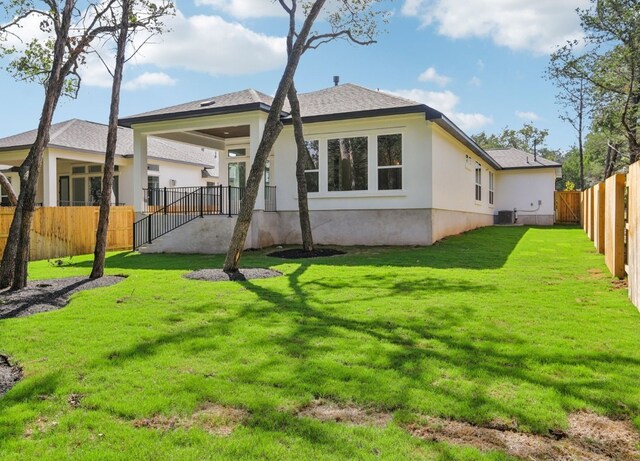151 William Hersee Dr, Bastrop, TX 78602 - back of property featuring stucco siding and a fenced backyard
