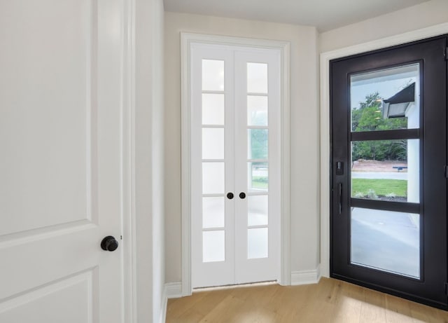 entryway with french doors and light wood-type flooring