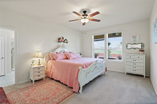 bedroom with ceiling fan and light carpet