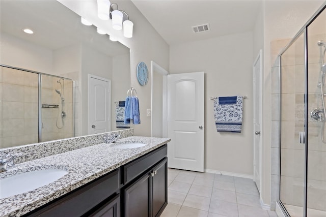 bathroom featuring vanity, tile patterned floors, and a shower with shower door