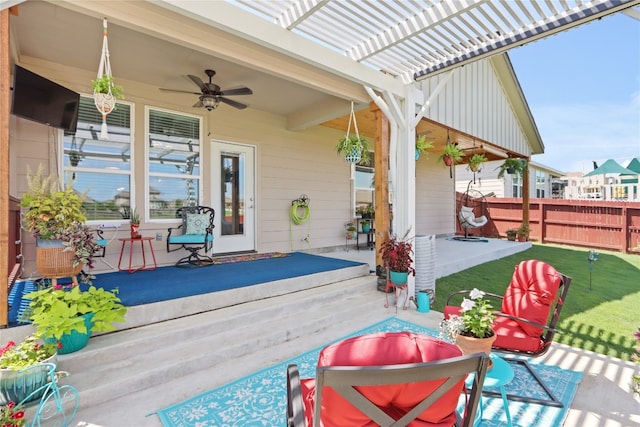 view of patio / terrace featuring ceiling fan, fence, and a pergola