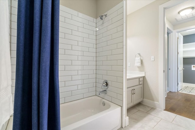 bathroom with hardwood / wood-style flooring, shower / bath combo, and vanity