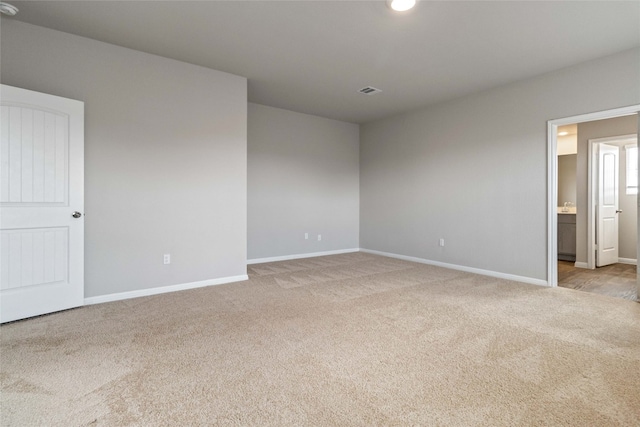 empty room with light colored carpet