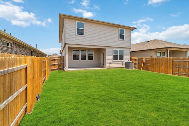 back of house featuring cooling unit, a lawn, and a patio area