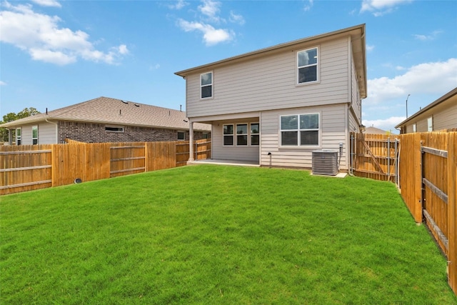 back of house with a yard and cooling unit