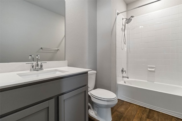 full bathroom with shower / tub combination, vanity, wood-type flooring, and toilet