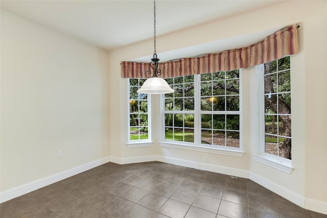 unfurnished dining area featuring a wealth of natural light and tile patterned flooring