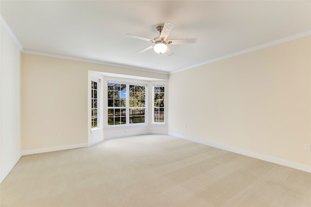 empty room featuring ornamental molding, light carpet, and ceiling fan