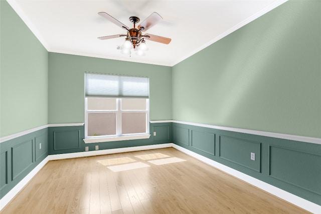 empty room with crown molding, ceiling fan, and light hardwood / wood-style floors