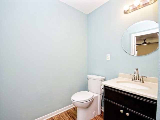 bathroom with vanity, toilet, and wood-type flooring