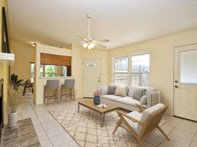 tiled living room with ceiling fan