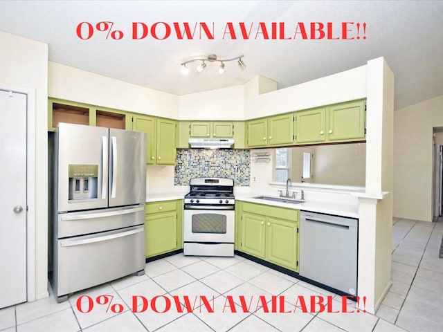 kitchen with sink, green cabinetry, and appliances with stainless steel finishes