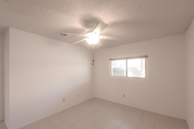 empty room featuring a textured ceiling and ceiling fan