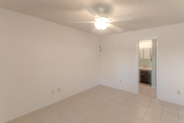 tiled empty room with sink and ceiling fan