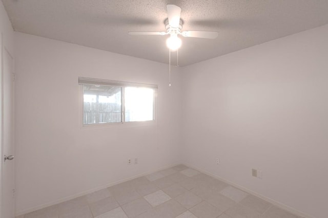 spare room featuring a textured ceiling and ceiling fan