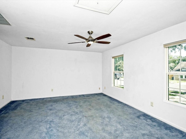 carpeted spare room with ceiling fan